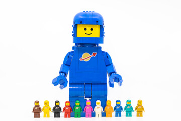 Fototapeta premium Hong Kong, June 8, 2026: A giant spaceman stands behind a lineup of eleven classic space minifigures.