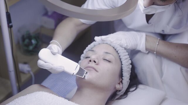 Ultrasonic skin scrubber gliding across a calm resting face