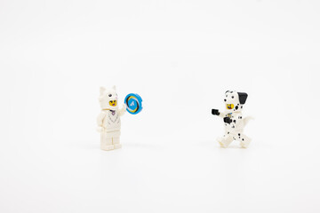 Fototapeta premium Hong Kong, June 8, 2026: minifigures dressed as a cat and dalmatian dog play together with a toy ring.