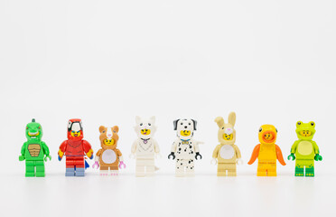 Fototapeta premium Hong Kong, June 8, 2026: A colorful row of minifigures in pet costumes including lizard, parrot, hamster, cat, dalmatian, rabbit, goldfish, and frog.