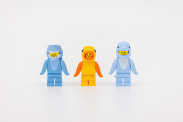 Fototapeta premium Hong Kong, June 8, 2026: Three toy minifigures wearing sea animal costumes feature a shark, fish, and dolphin.