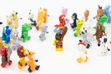 Fototapeta premium Hong Kong, June 8, 2026: A caveman holding a club stands confidently amidst a large group of diverse animal suit minifigures.