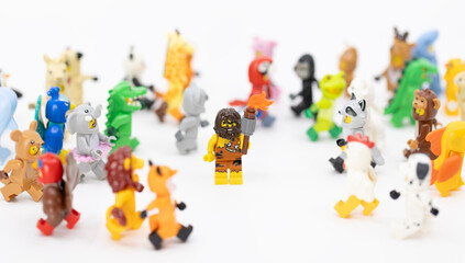 Fototapeta premium Hong Kong, June 8, 2026: A caveman holding a club stands confidently amidst a large group of diverse animal suit minifigures.