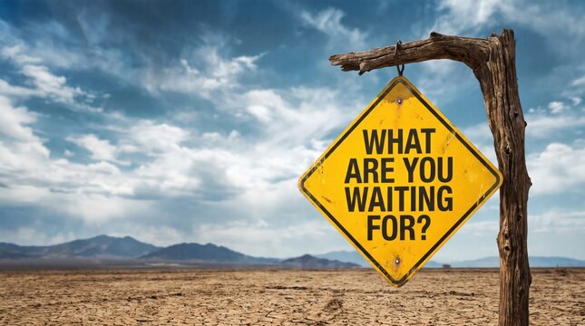 A weathered yellow diamondshaped sign with the text what are you waiting for hanging from a rustic wooden post in a barren desert landscape