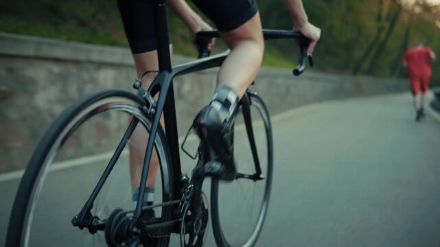 Cyclist Riding Road Bicycle Along Asphalt Path In Park