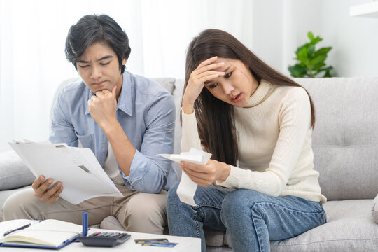 Family financial concept, Stressed wife and husband have a problem to pay loan can not pay credit card debt.