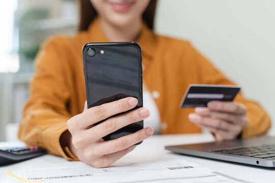 hands of woman using mobile smart phone for scan and payment bill online