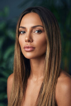 Close-up portrait of a beautiful woman with long straight hair looking at the camera