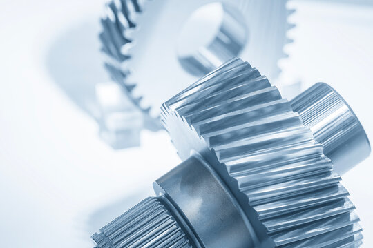 Close up of automotive bevel gear parts in dramatic blue tone lighting