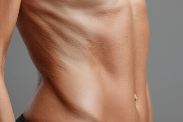 Naklejka premium Slim toned abdomen with soft skin folds and smooth even tone conveying confidence and health