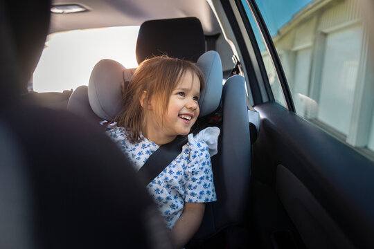 Happy girl looking out of window during road trip