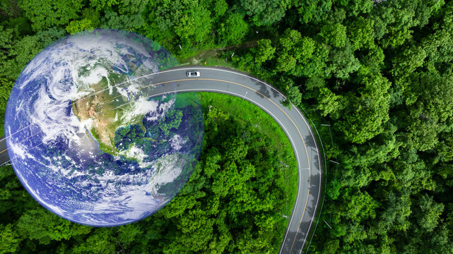 Aerial view BEV car on asphalt road with green tree forest, EV car electric vihicle car on forest road with globe earth planet, Green energy and eco power sustainable.