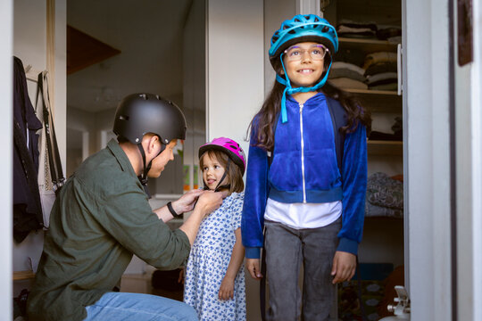 Father and his two daughters getting ready for outdoor activity