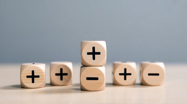 Wooden blocks with plus and minus symbols representing business profit and loss analysis and decision making concepts