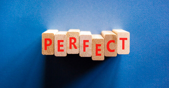 Perfect word symbol. Concept word Perfect on beautiful wooden blocks. Beautiful blue background. Business perfect word concept. Copy space.