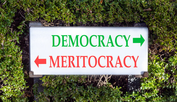 Democracy or meritocracy words symbol. Concept words Democracy Meritocracy on beautiful white sign plate. Beautiful green leaf background. Business democracy meritocracy concept. Copy space
