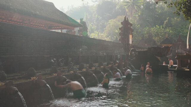 Tirta Empul Temple Bali Indonesia sacred purification ritual with visitors bathing at the holy spring water temple complex