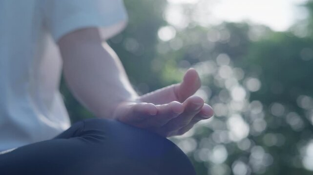 woman practicing meditate on the park. Asian woman doing exercises in morning. balance, recreation, relaxation, calm, good health, happy, relax, healthy lifestyle, reduce stress, peaceful, Attitude.