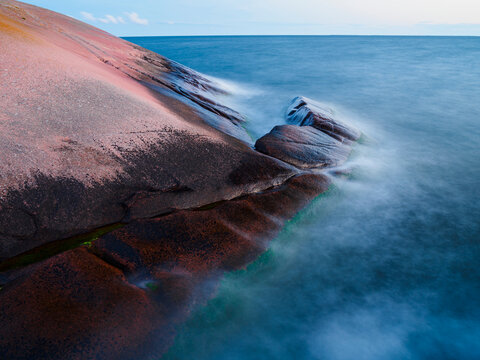 Long exposure of water splashing on hill at sea