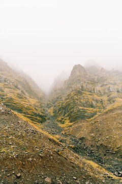 Rocky mountain valley covered with fog