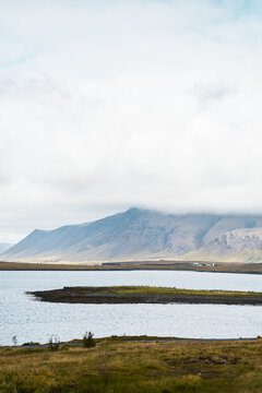 A serene lake and mountain landscape with clouds