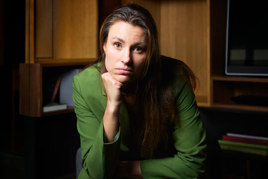 Portrait of businesswoman leaning on elbow at office