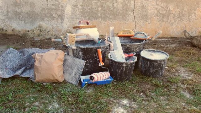Home renovation with building materials, plaster, paint, and tools for interior construction and finishing work. Concept: providing construction, repair, and finishing services.