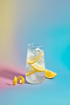 A cool and refreshing lemonade cocktail with lemon slices, and ice