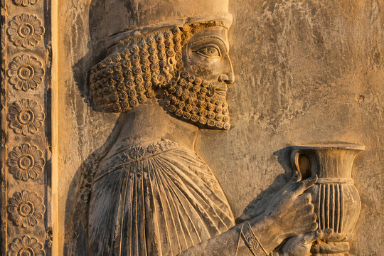 Weathered stone bas-relief from Persepolis depicting a tribute bearer.