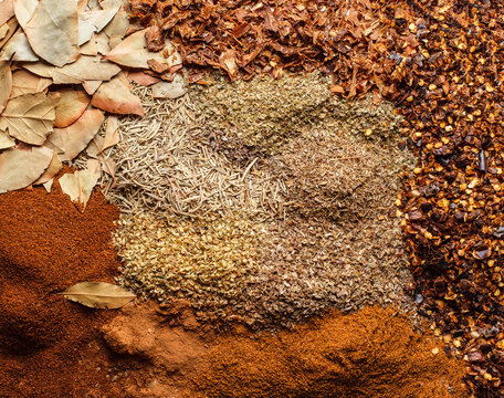 Overhead composition of colorful dried spices, herbs and seasonings.