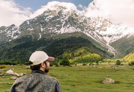 Traveler admiring snowy mountain peak