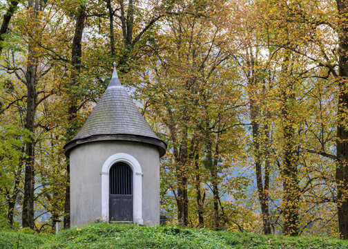 Small Woodland Shrine Surrounded By Autumn Forest Trees