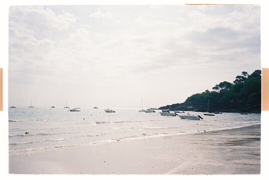 Small boats anchored near a quiet sandy beach