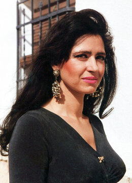 Elegant spanish woman wearing traditional earrings outdoors