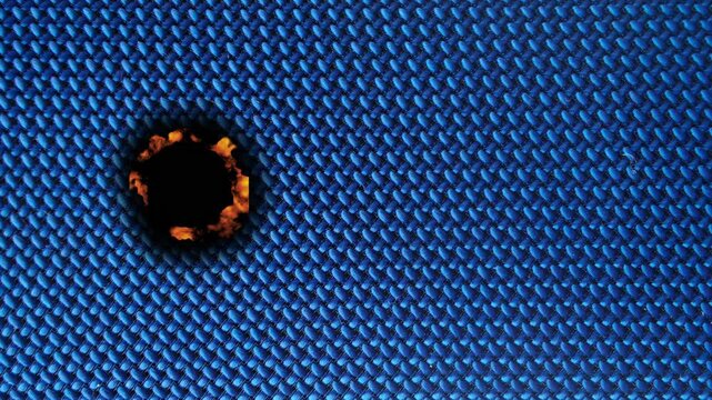 Burning process and damage to fabric under microscope at a lab