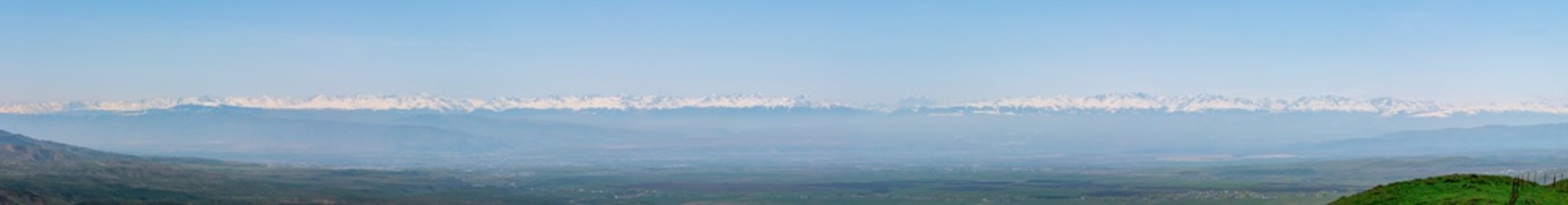 Tianshan Panorama: The Majestic Skyline of Rolling Snowy Peaks.