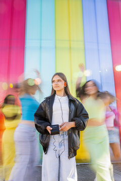 Teenager Listening to Music with Walkman and Dancing Women