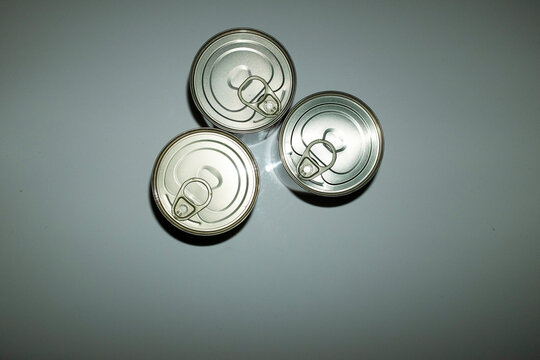 Silver shiny metal aluminium food cans with hard direct flashlight