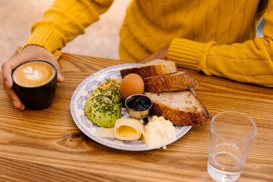 Anonymous man preparing to enjoy a traditional Danish breakfast 