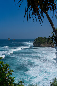 The vast, blue expanse of the sea viewed from atop the cliffs at Tanjung Penyu, Malang.