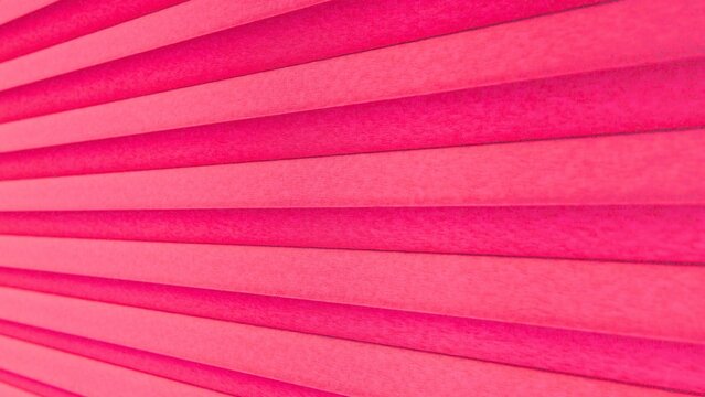 Pleated pink paper background texture with diagonal lines and shadow