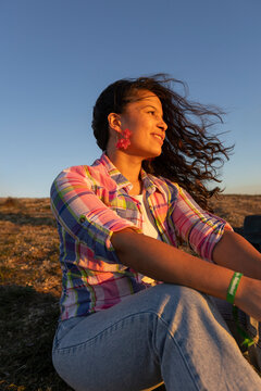 Woman in the park in sunlight with breeze on the hair