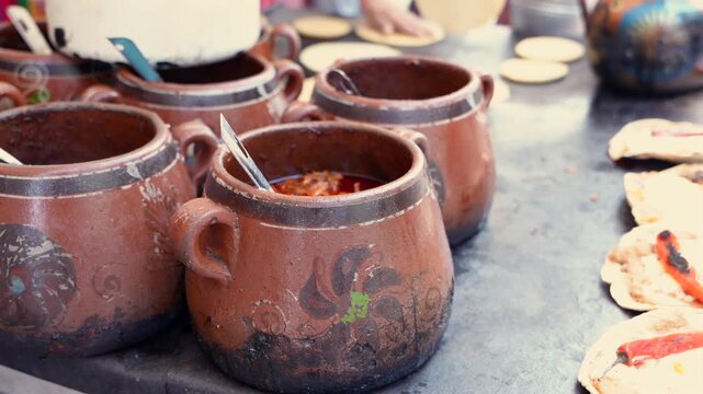 Traditional mexican birria stew cooking at a street food market