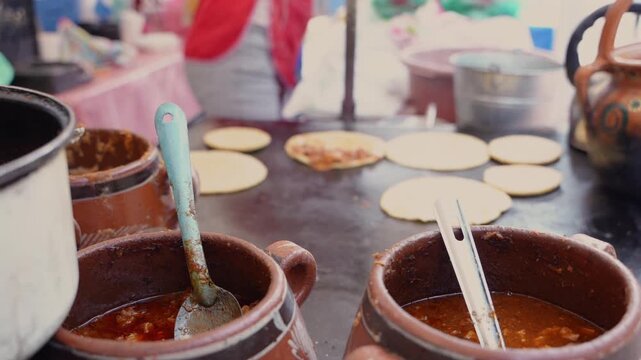 Mexican street food vendor cooking gorditas on comal