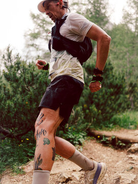 Portrait of a trail athlete during the race across a mountain 