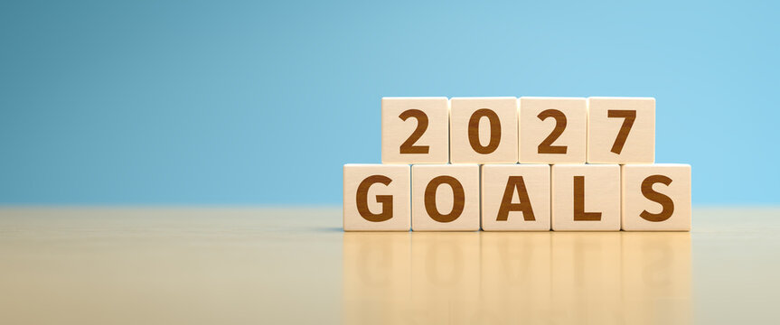 Wooden toy cubes forming the text "2027 GOALS". Concept for planning the actions and goals for 2027.
