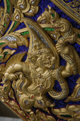 Obraz premium Ornate golden decorations, traditional Thai craftsmanship, wood carving and mosaic details of royal barges in Bangkok, Thailand