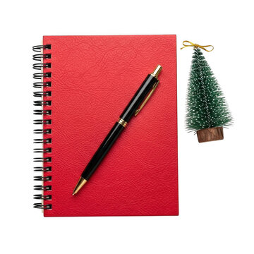 Red notebook with pen and christmas tree decoration