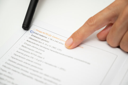 Close up of pen pointing at maternal age high risk factor on obstetrics report