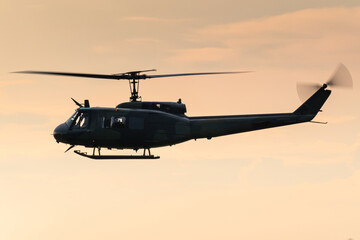 A Bell UH-1 Huey military helicopter during a beautiful sunset.  © spacekris